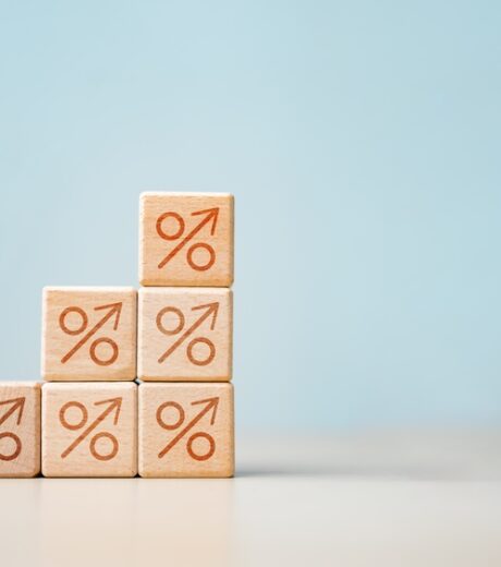 interest, rates, compare, savings, deposit, Stacked wooden blocks with percentage symbols and arrows pointing upward, representing rising interest rates, finance, inflation, and investment growth.
