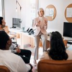 Business, mature manager or training team in office on risk management, financial planning or compliance. Finance department, diversity or people with upskilling to assess sales performance or budget