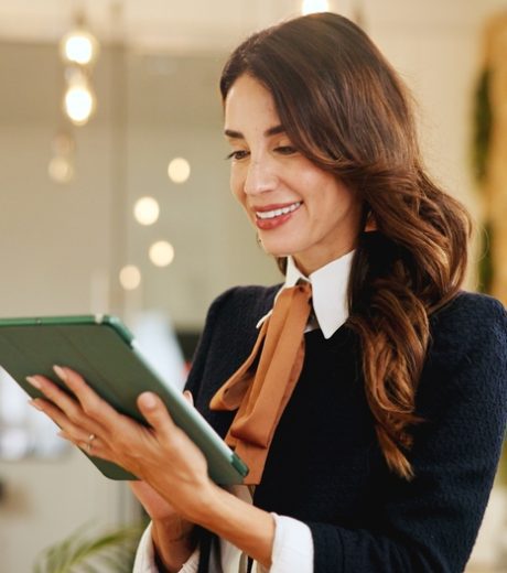 Smile, business woman and tablet in hotel for online booking, reservation schedule or information update. Digital technology, worker and internet communication with hospitality manager on checkin app