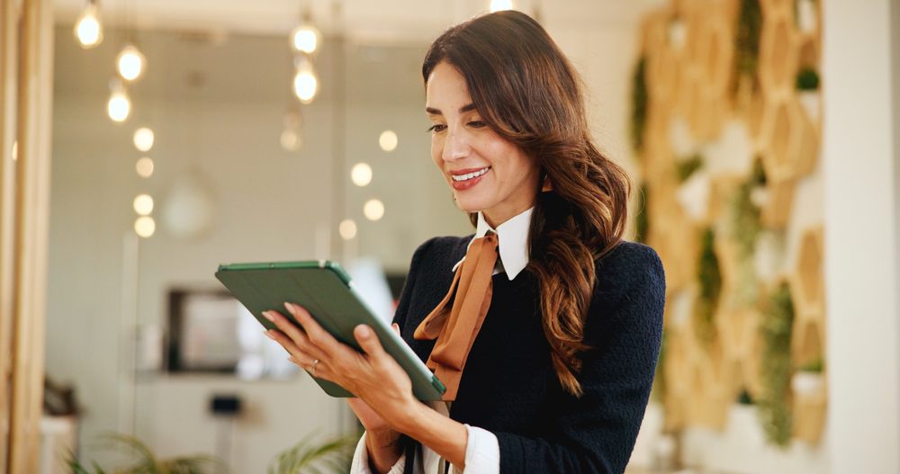 Smile, business woman and tablet in hotel for online booking, reservation schedule or information update. Digital technology, worker and internet communication with hospitality manager on checkin app