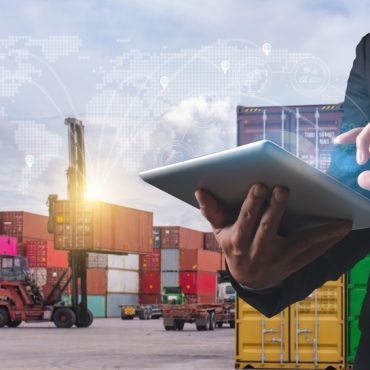 A professional man uses a tablet to manage and track shipping containers, with a futuristic global logistics network overlay