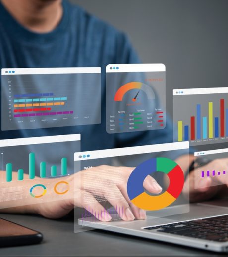 Business analyst working on laptop with holographic dashboard charts and data visualization graphs. Concept of big data, analytics, business intelligence, and financial statistics. crm marketing